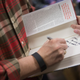 Sen. Ted Cruz (R-Texas) autographs a book for a supporter during a campaign event at CrossRoads Shooting Sports gun shop and range on December 4, 2015 in Johnston, Iowa.